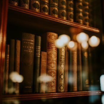 A close up of books behind a glass case